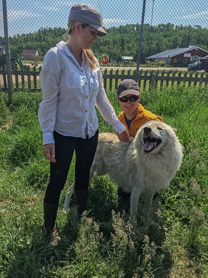 Juliana Dever inside a wolf pen Quebec Canada